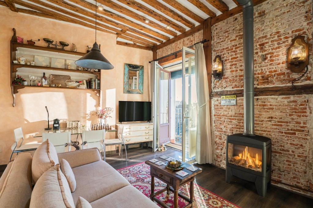 a living room with a couch and a fireplace at 1851: Exceptional 19th century studio in Madrid in Madrid