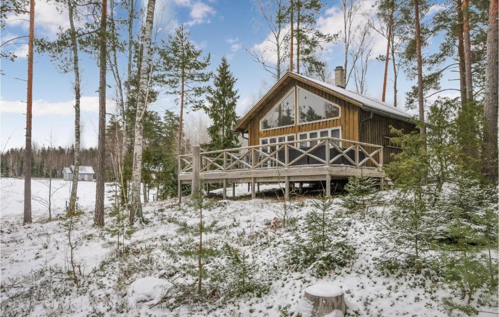 a log cabin in the woods in the snow at 2 Bedroom Cozy Home In Klssbol in Klässbol