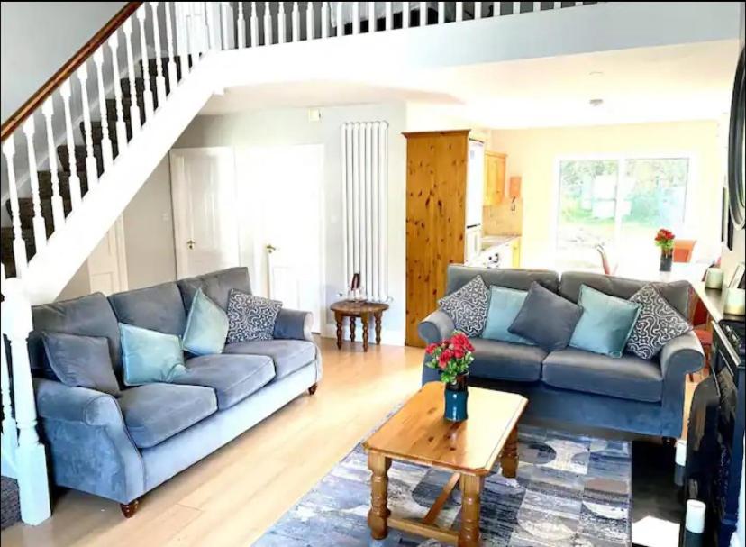 a living room with a couch and a table at The Robins Rest in Killarney