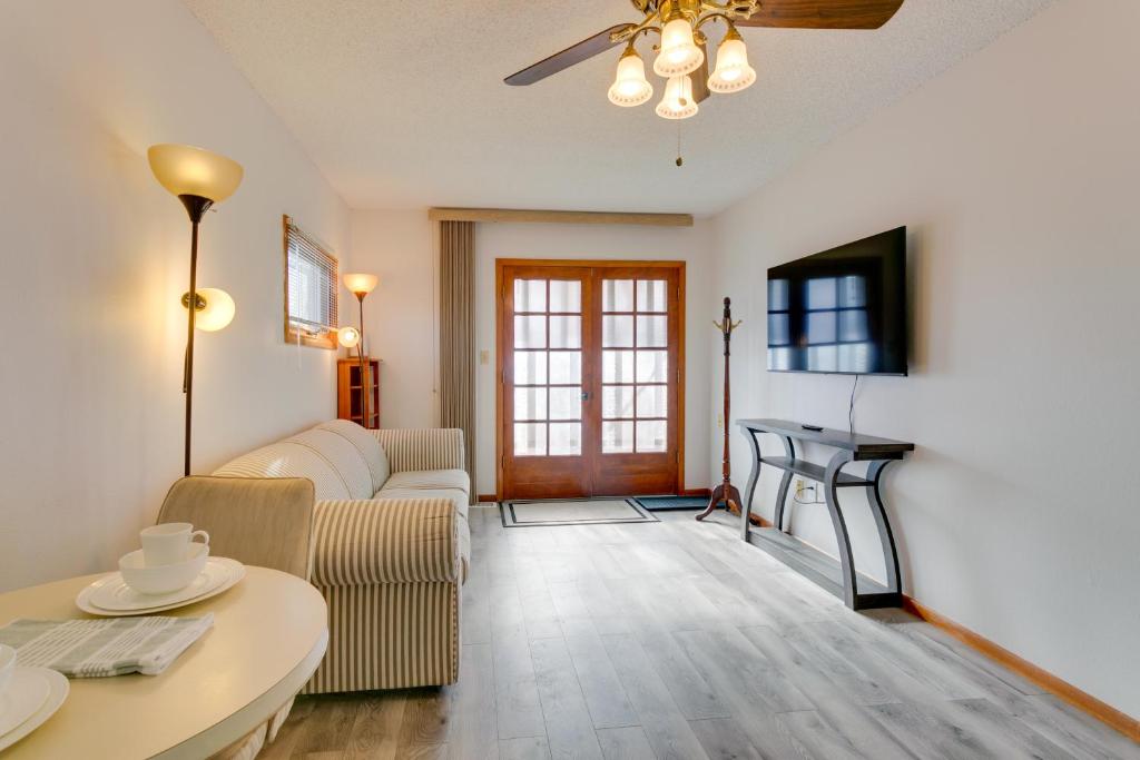 a living room with a couch and a table at 1 Mi to Metro Station Cozy Aurora Horse Farm Apt! in Aurora