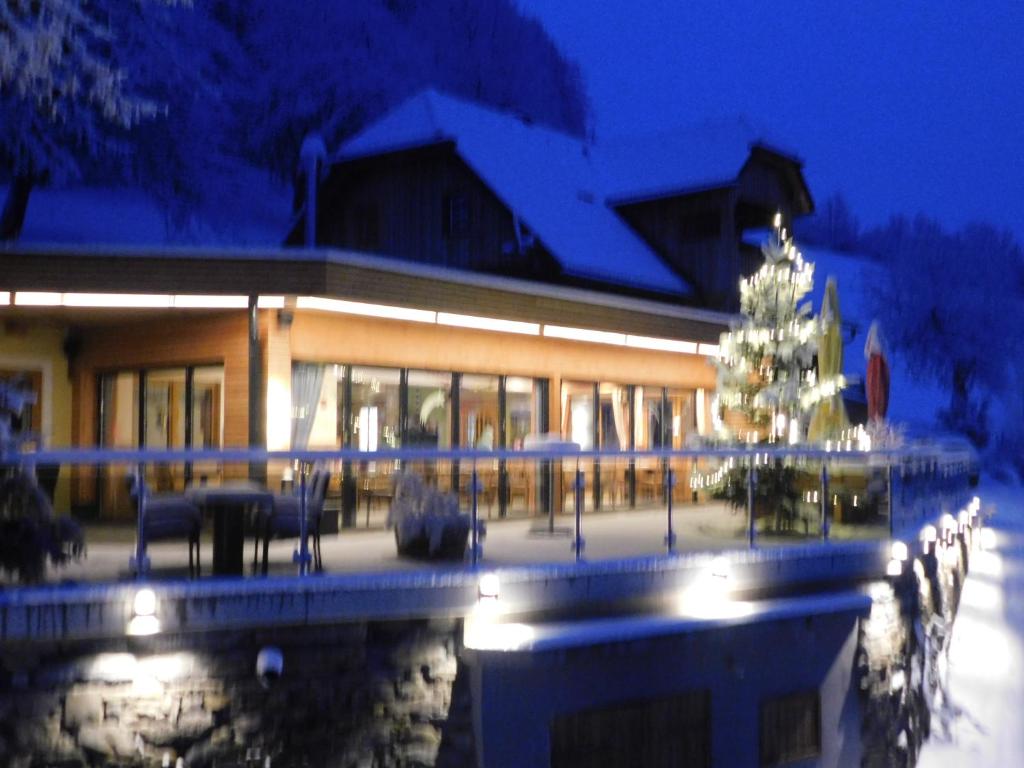 a building with a christmas tree in front of it at Gasthof Trattner Pension Waldhof in Sankt Peter am Kammersberg