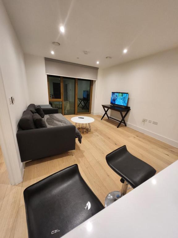 a living room with a couch and a table at Stunning 2-Bed Apartment in Brentford in Brentford