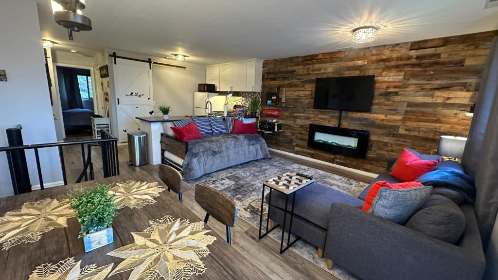 a living room with two couches and a tv at Ski on Ski off Mtn Chalet in Vernon