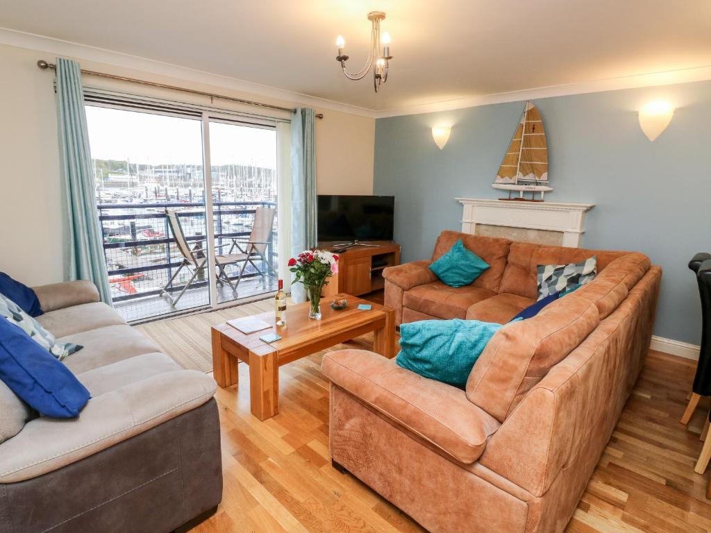 a living room with two couches and a television at Mountbatten House in Plymouth