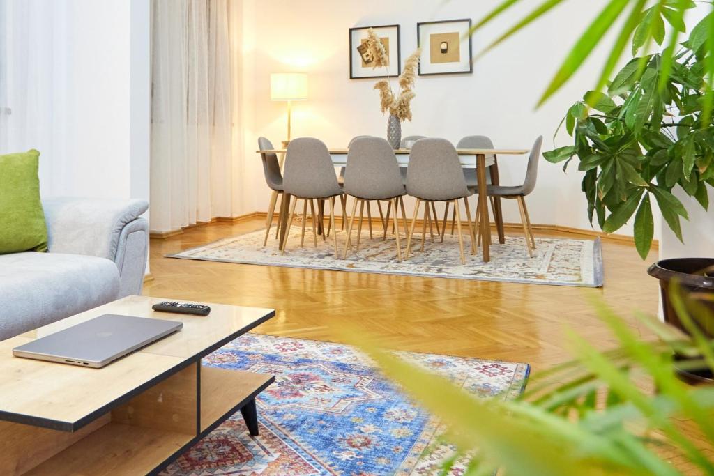 a living room with a table and chairs at Caragiale Apartment in Bucharest