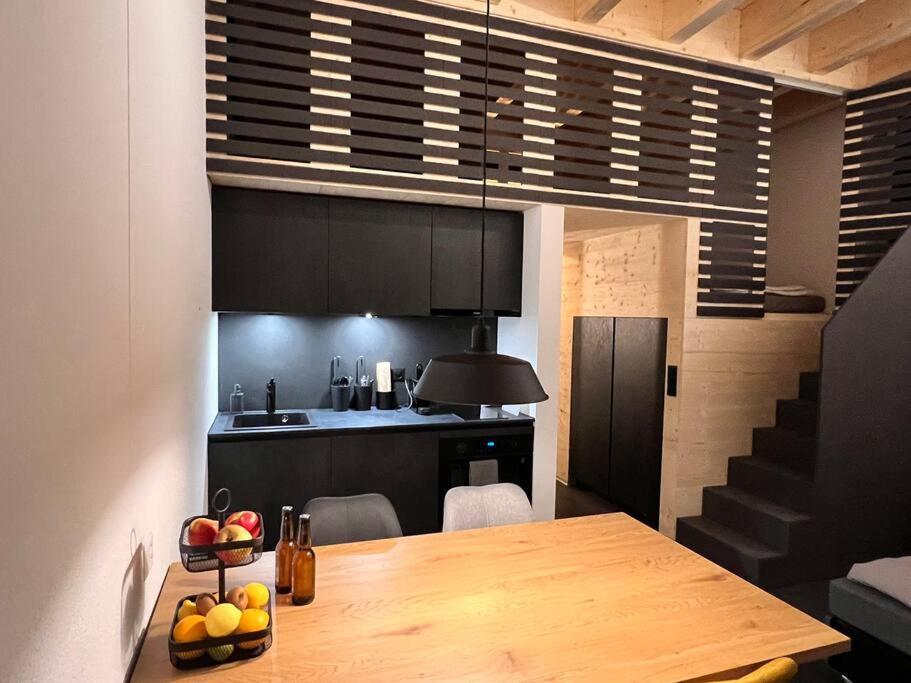 a kitchen with a wooden table in a room at studio suite im fresh-cube 