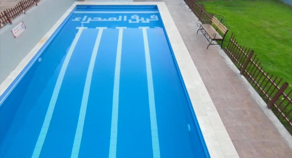 a large swimming pool with blue paint on it at Bonsian in Ghumrah