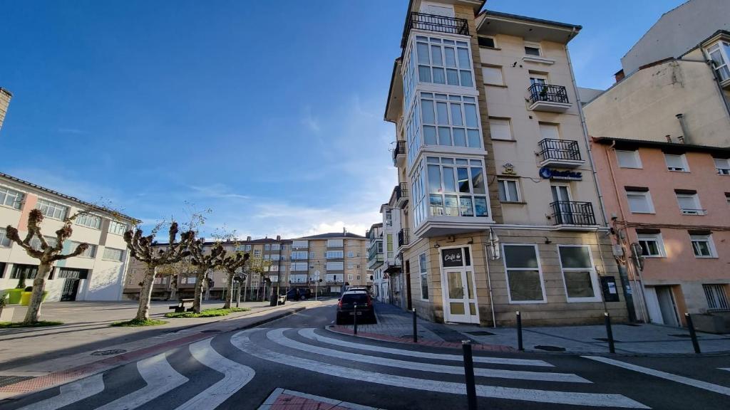 una calle urbana vacía con un edificio y un paso de peatones en Sol y Nieve Campoo, en Reinosa