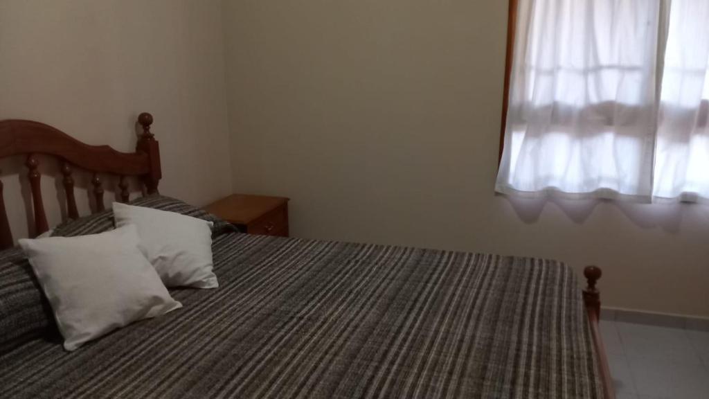 - une chambre avec un lit avec deux oreillers et une fenêtre dans l'établissement Casa Castelli, à San Rafael