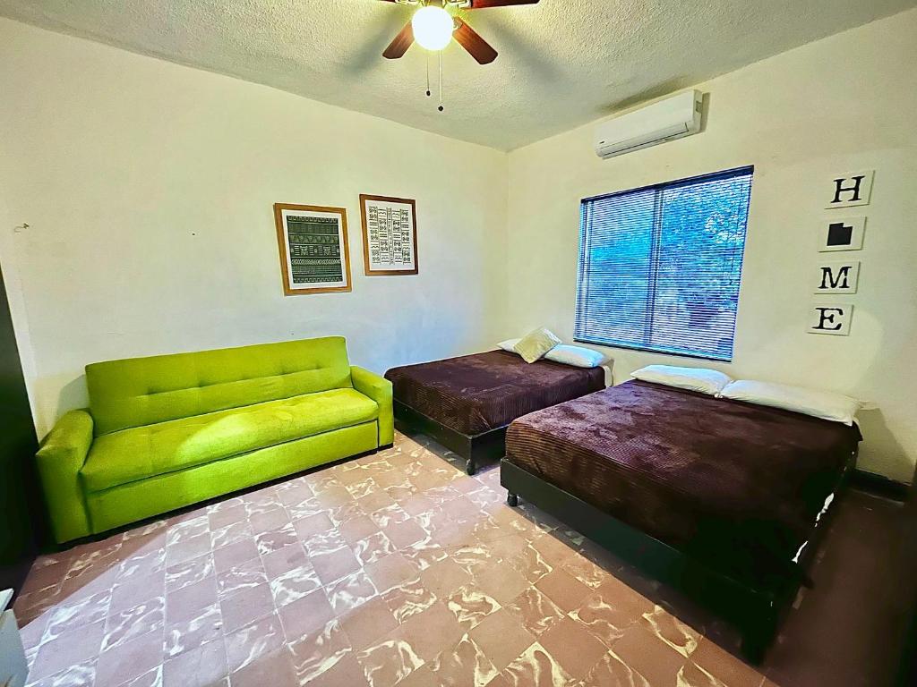a living room with two beds and a couch at Confortable Loft MN 960 D Centro Mty cerca de todo in Monterrey