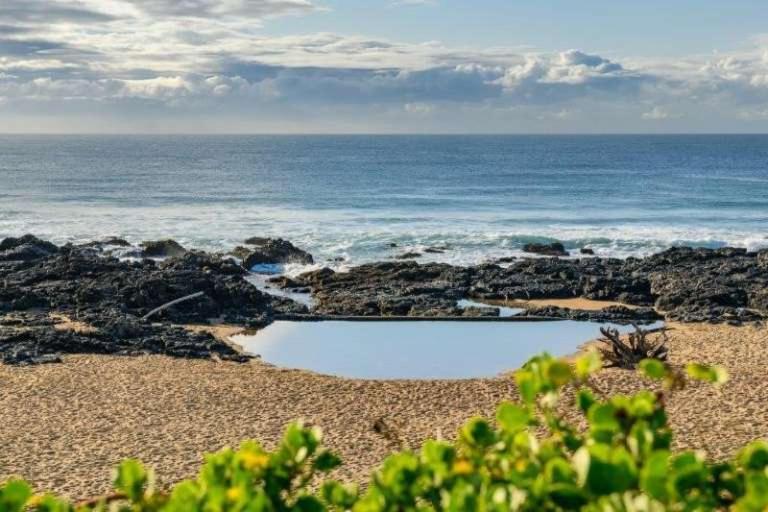 a view of the ocean from a rocky beach at Timber Ally Cabin in Umtentweni