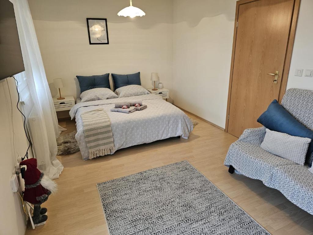 a bedroom with a bed with a stuffed animal on it at Apartman Šimun in Varaždin