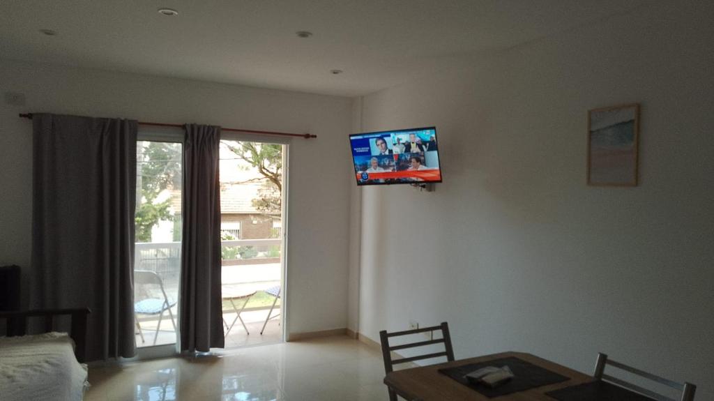 sala de estar con TV de pantalla plana en la pared en Departamento a estrenar GALO VII en San Bernardo
