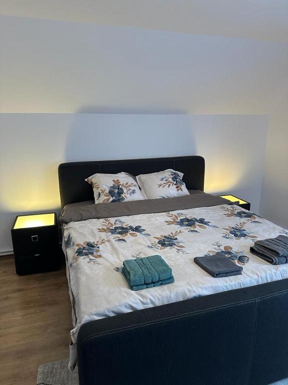a bed with two pillows and towels on it at CASA ANA Apartament 2 in Câmpulung Moldovenesc