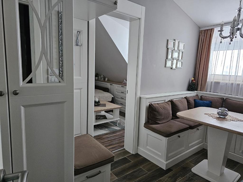 a room with a desk and a couch and a table at Apartman Maglic 412 Lux in Kopaonik