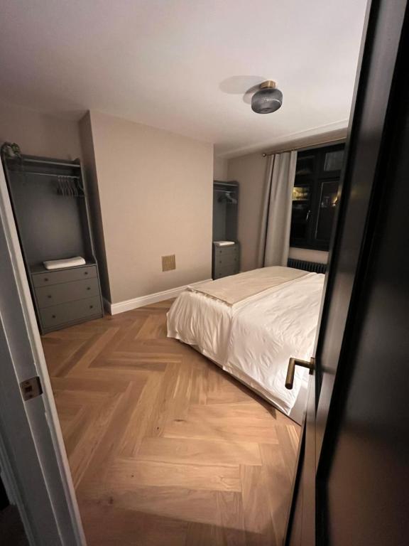 um quarto com uma cama e piso em madeira em Bath Gem em Bath