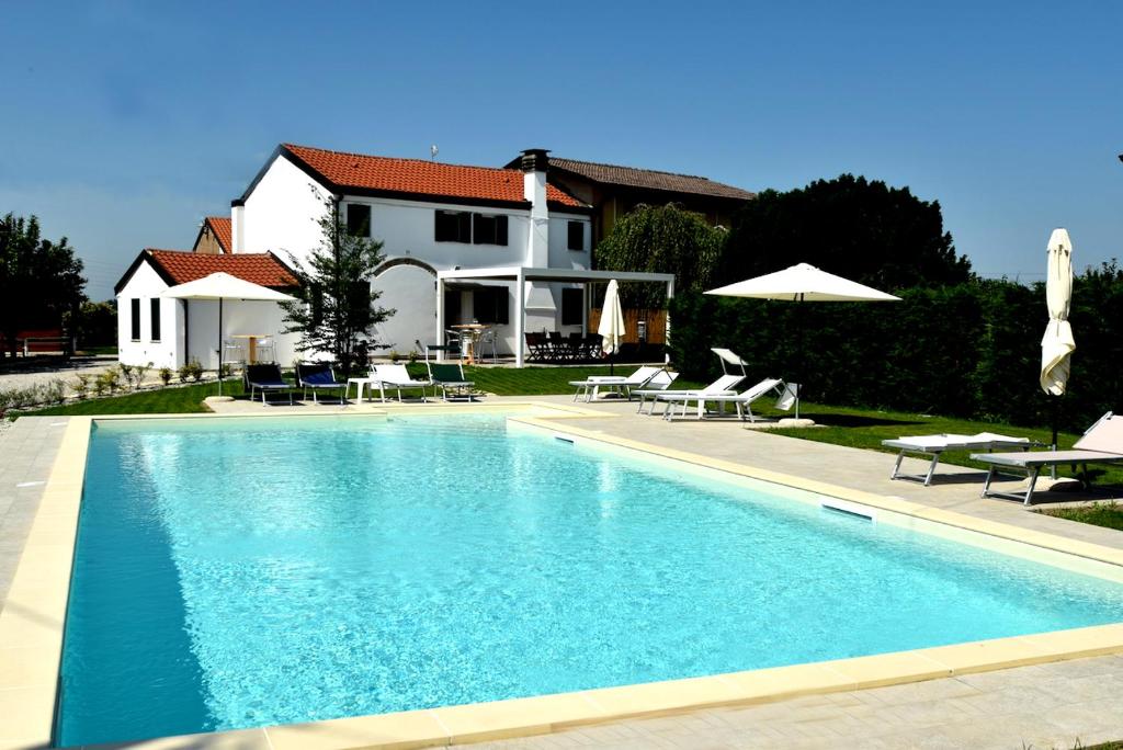 a large swimming pool in front of a house at Adria bnb in Adria