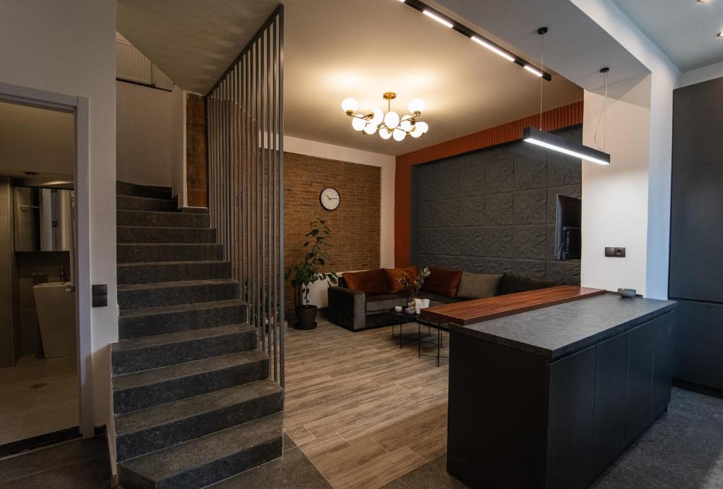 a lobby with a staircase and a living room at Nice and cosy villa in the heart of the city in Tbilisi City