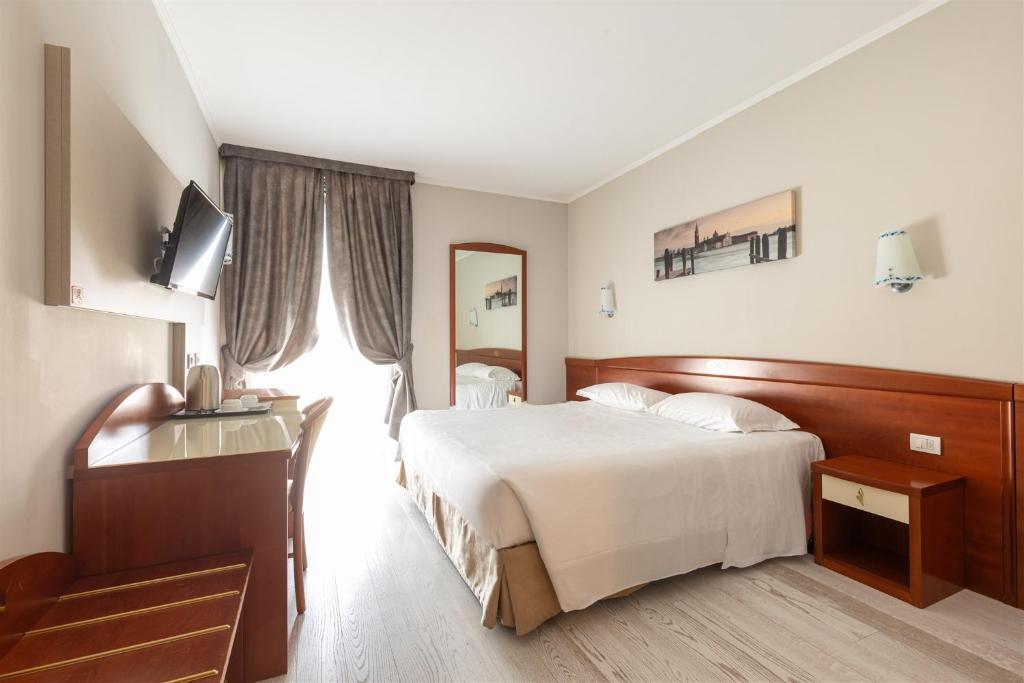 Postel nebo postele na pokoji v ubytování Noventa Hotel