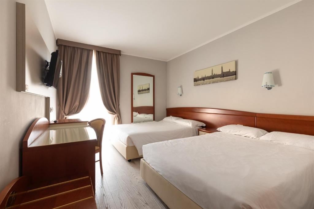 Postel nebo postele na pokoji v ubytování Noventa Hotel
