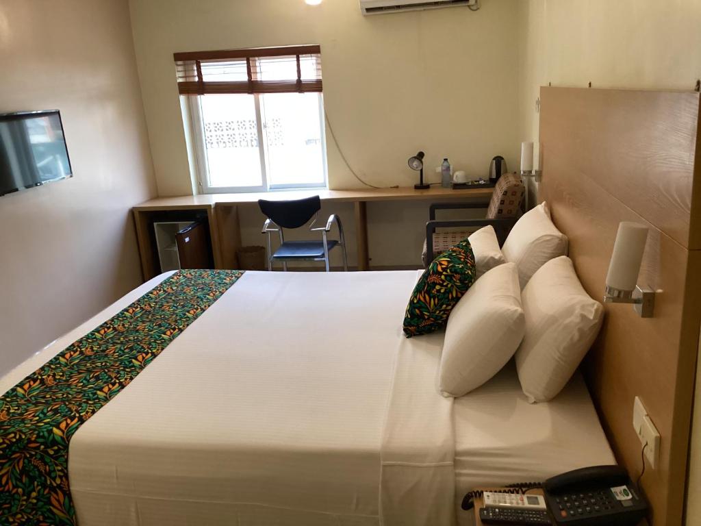 Postel nebo postele na pokoji v ubytování Adis Hotels Ibadan
