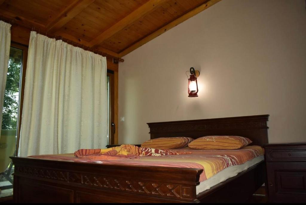 a bedroom with a large bed with a window at Shasi Eco Lodge in Ambula