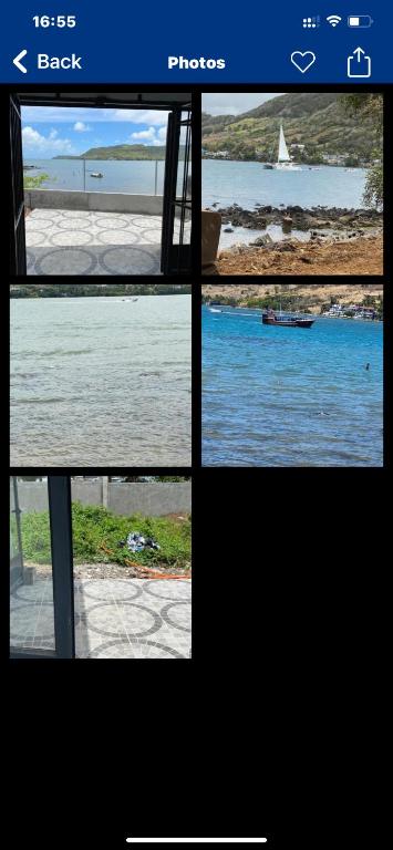 a window view of a beach with a boat in the water at Ashan Luxury Seafront Villa 2 in Grande Rivière Sud Est