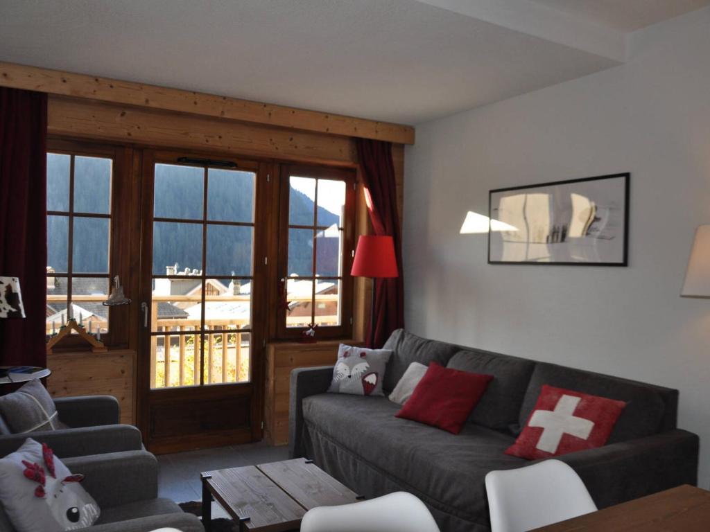 a living room with a couch and a table at Appartement Central avec Piscine, Proche Remontées et Multi Pass Inclus à Châtel - FR-1-693-105 in Châtel