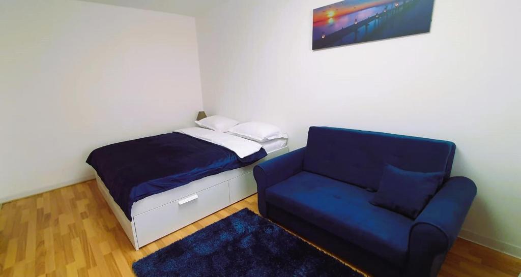 a small bedroom with a bed and a chair at Casa Rusu - Govandari -Self check in-24h Netflix in Reşiţa