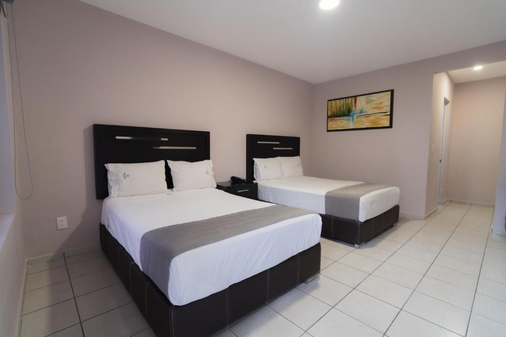 Postel nebo postele na pokoji v ubytování Expo Hotel Guadalajara - Zona Expo frente al Centro de Convenciones