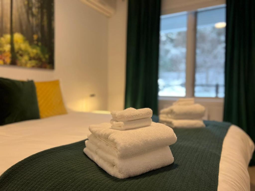 three stacks of towels sitting on top of a bed at Suite 205 - Destination Mont-Orford in Magog-Orford