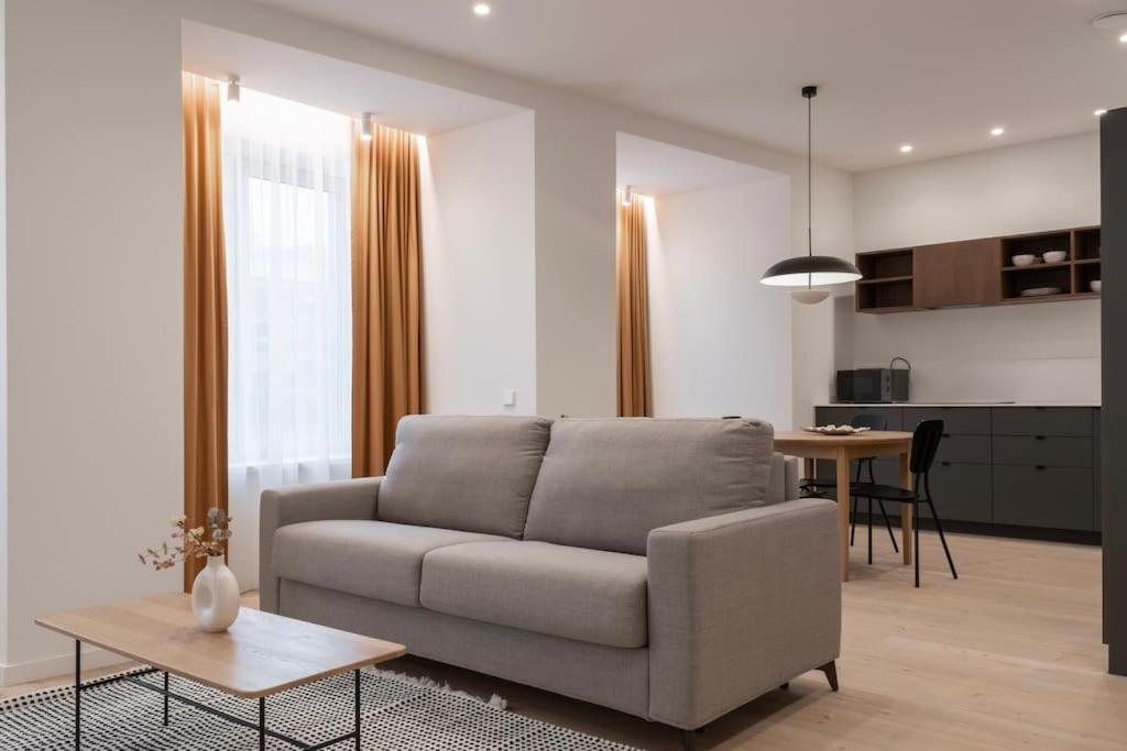 a living room with a couch and a table at Downtown getaway apartments by Prime Rentals IV in Kaunas