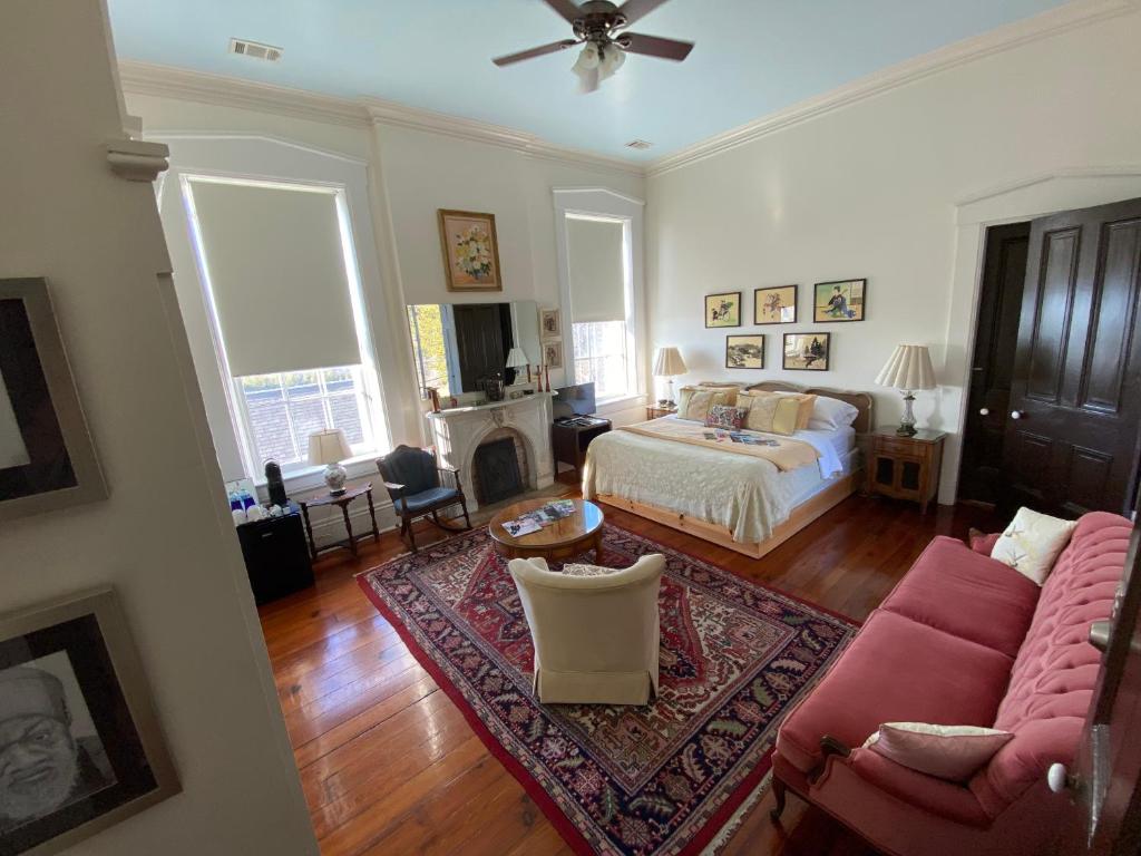 een woonkamer met een bed en een bank bij Bazsinsky House in Vicksburg