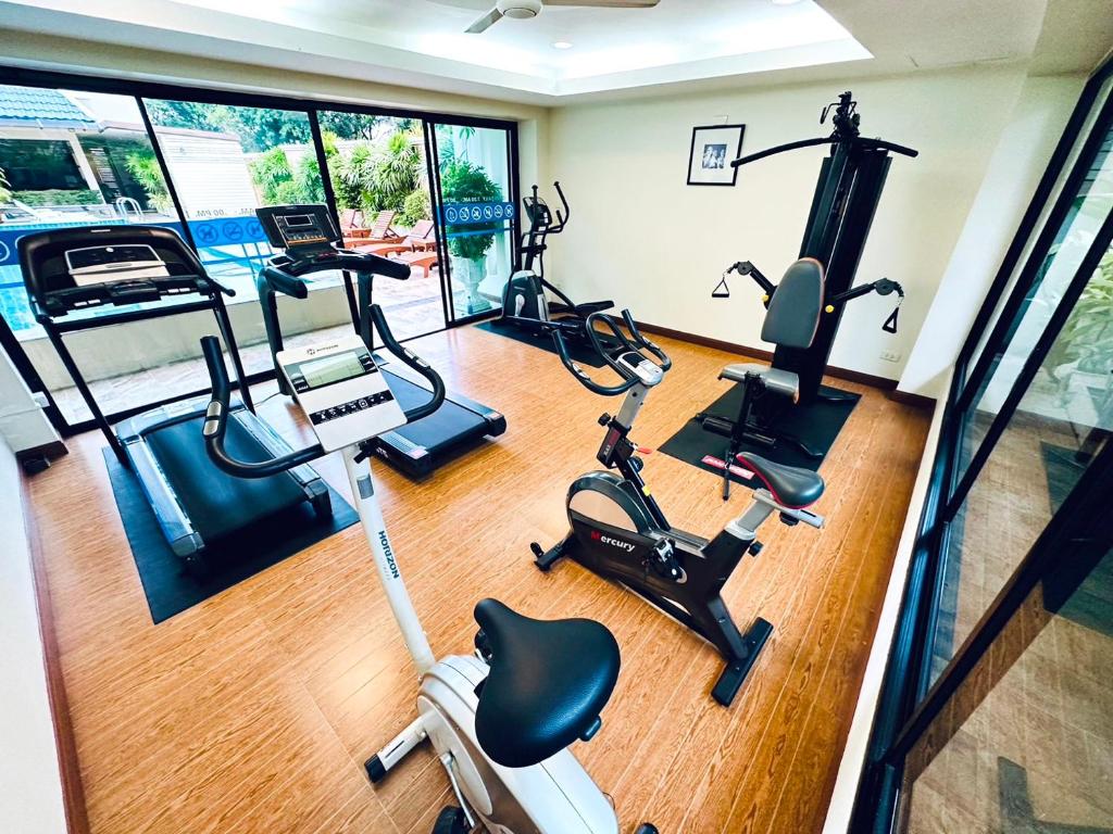 A bright compact gym with treadmills, cycling equipment and a multi-gym machine.