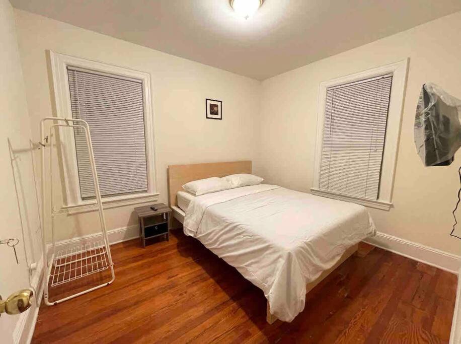a bedroom with a bed and two windows at Entire Beautiful 1BR for You! [R] in Whitestone