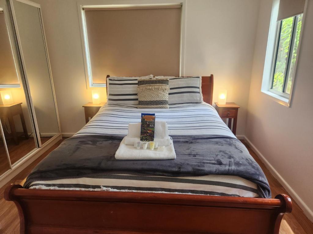 a bedroom with a bed with two towels on it at Oakey Creek Private Retreat in Gheerulla