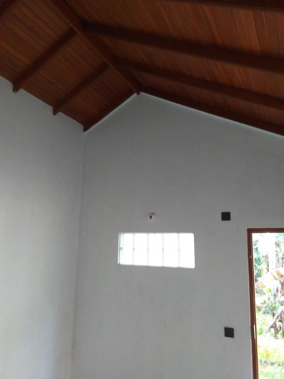a white room with a window and a wooden ceiling at Bel vedere in Minuwangoda