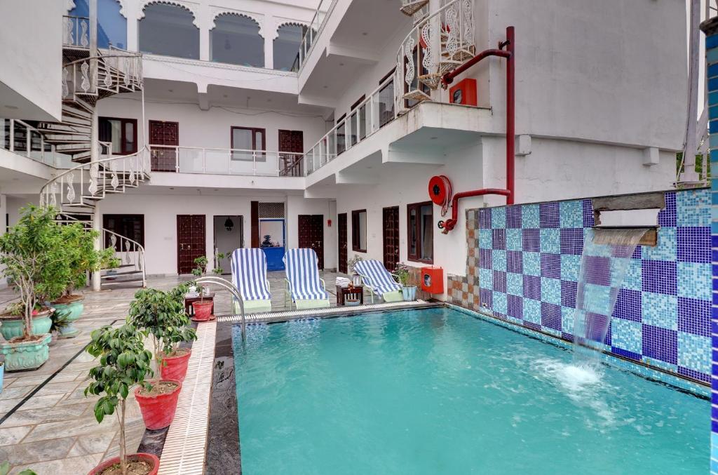a swimming pool in the middle of a building at Hotel Darbargarh, Udaipur in Udaipur