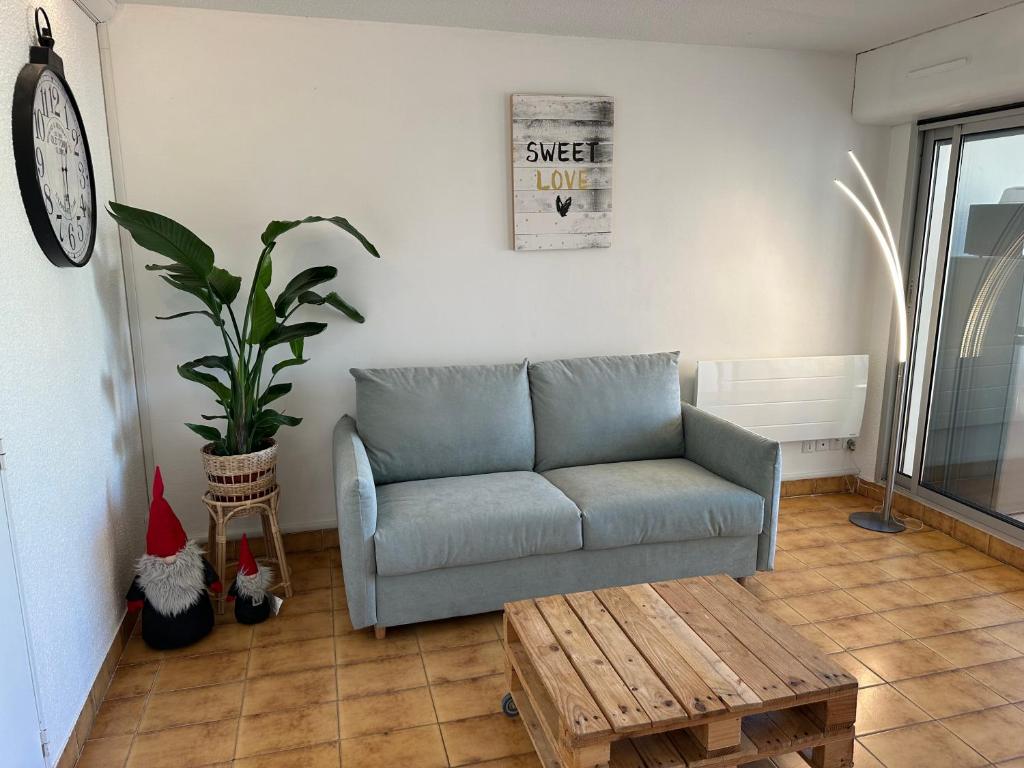 a living room with a couch and a coffee table at HELiOS in Cap d'Agde