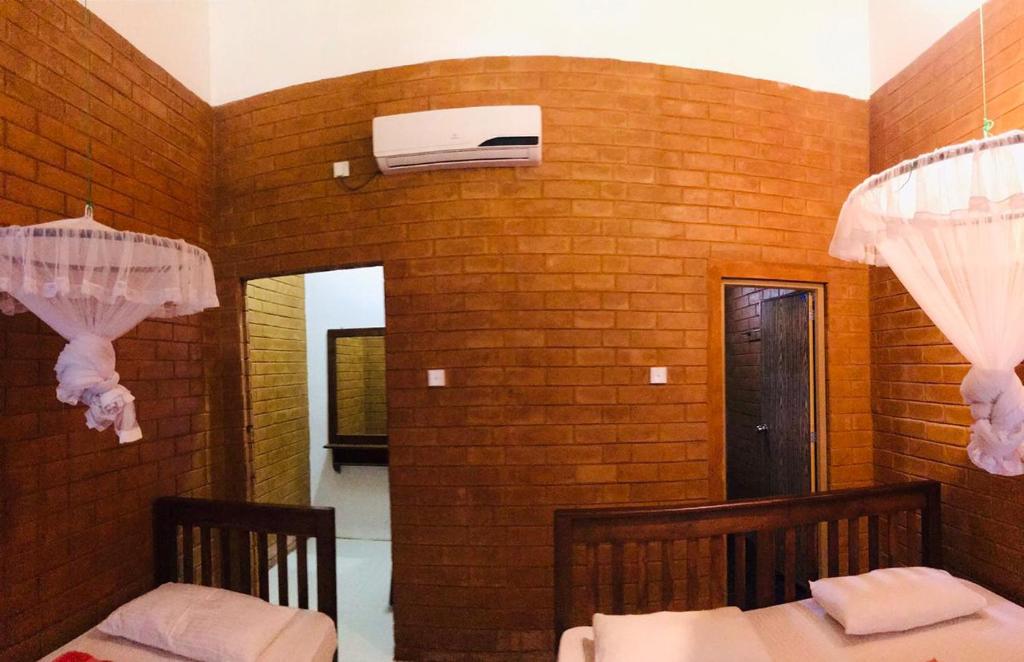 Postel nebo postele na pokoji v ubytování Anuradhapura Kanimadala Resort