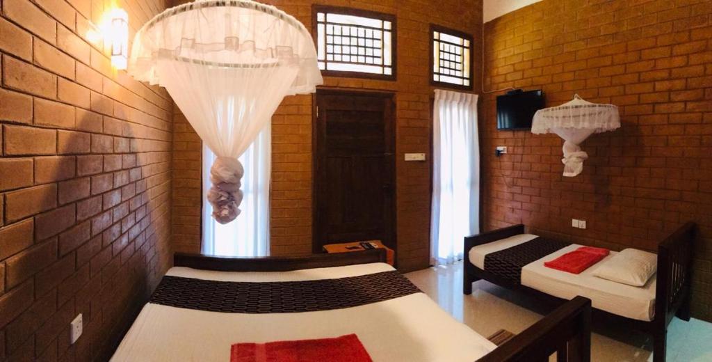 Postel nebo postele na pokoji v ubytování Anuradhapura Kanimadala Resort