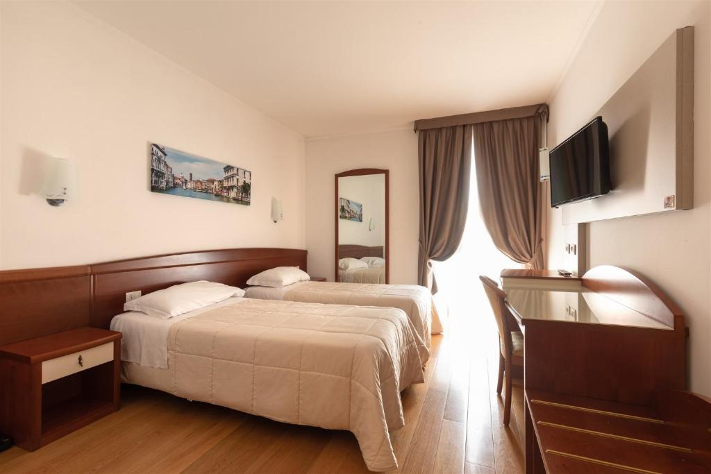 Postel nebo postele na pokoji v ubytování Noventa Hotel