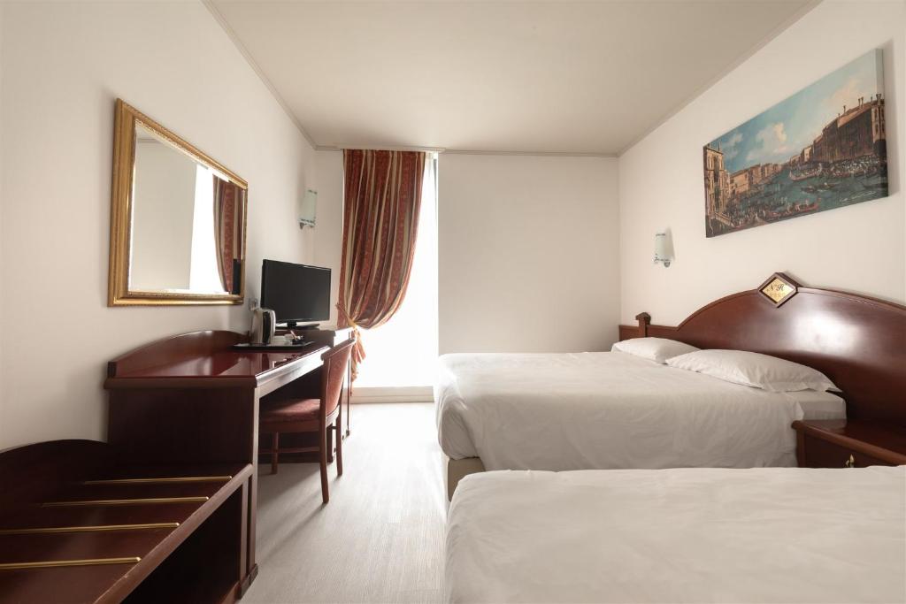 Postel nebo postele na pokoji v ubytování Noventa Hotel