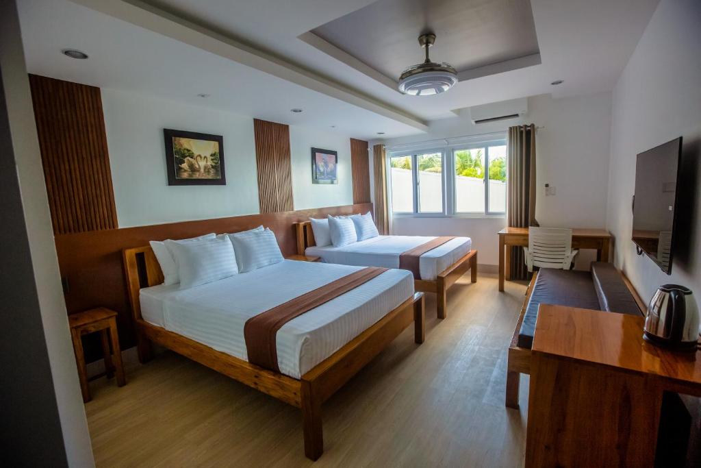 Postel nebo postele na pokoji v ubytování Horizon Hotel Romblon