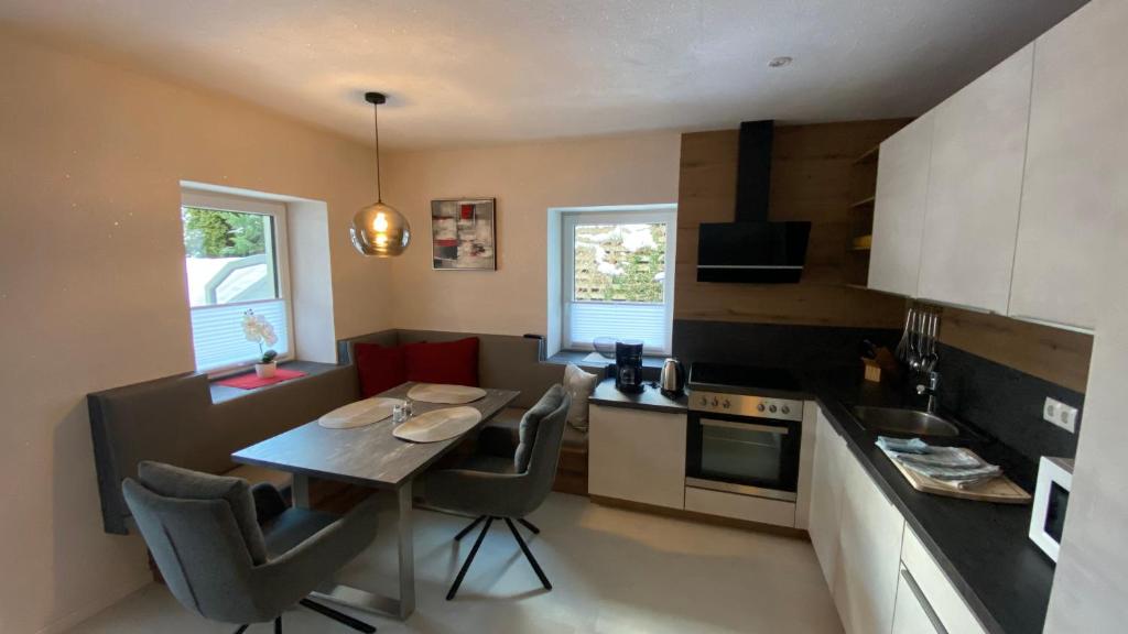 a kitchen with a table and chairs in a room at Ferienhaus2-Sölden in Sölden