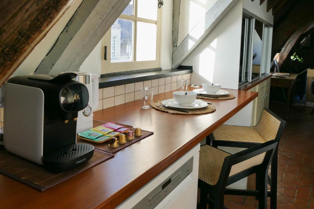 a kitchen with a counter with a coffee maker on it at Suite Toussaint - Calme &amp; Authentique in Angers