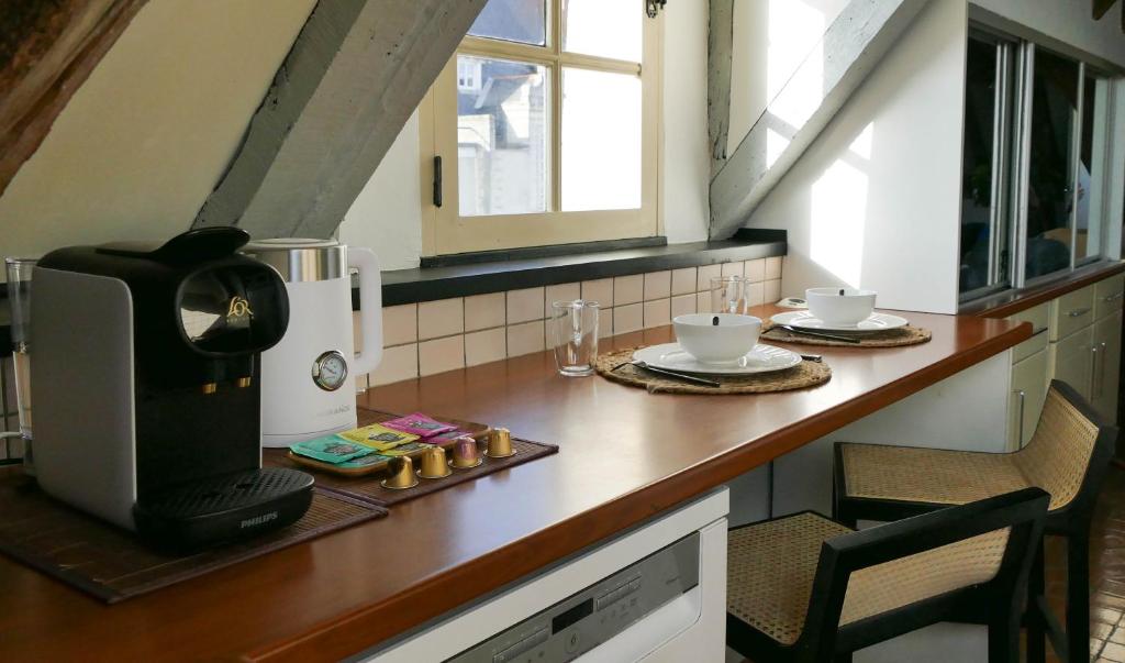 a kitchen with a counter with a coffee maker on it at Suite Toussaint - Calme &amp; Authentique in Angers