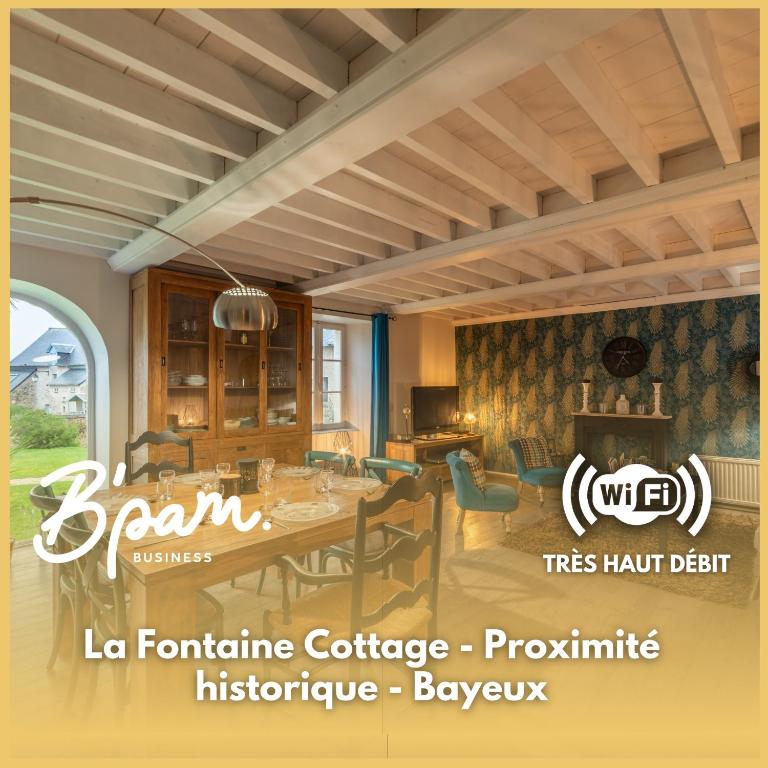 une salle à manger avec une table dans l'établissement La Fontaine Cottage - Proximité historique - Bayeux, à Saint-Loup-Hors