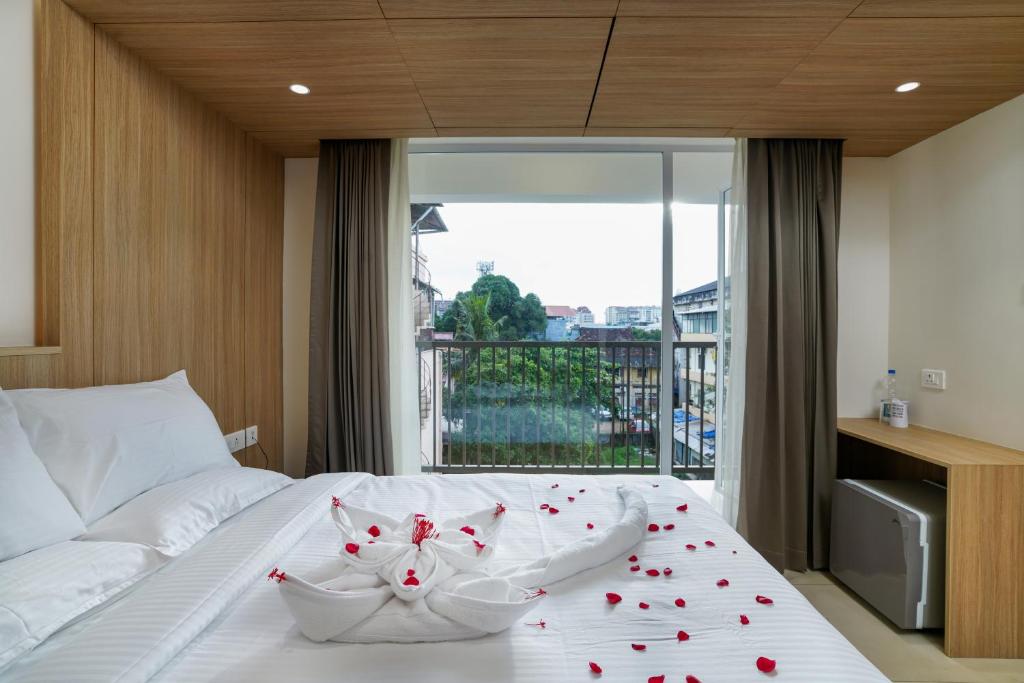 a bedroom with a bed with red hearts on it at The Trios Hotel in Cochin