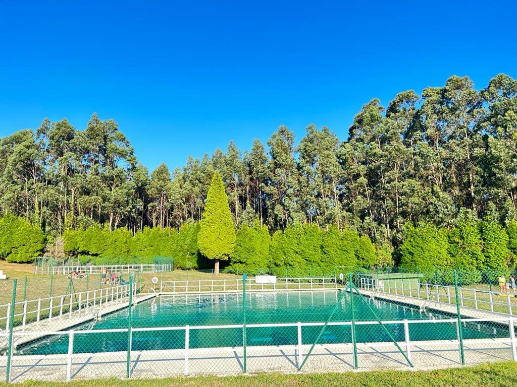 The swimming pool at or close to Pensión San Ciprian Urbanización RíoCobo